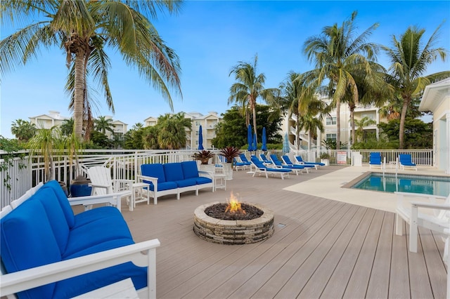 7611 34th Ave W Unit 301, Bradenton, FL 34209 - wooden terrace featuring an outdoor living space with a fire pit and a community pool