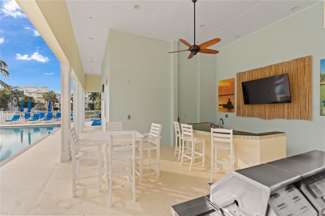 7611 34th Ave W Unit 301, Bradenton, FL 34209 - view of patio / terrace with a bar, a community pool, and ceiling fan