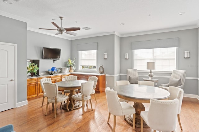 7611 34th Ave W Unit 301, Bradenton, FL 34209 - dining space with light wood-style floors, ceiling fan, and ornamental molding