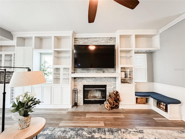 25640 State Road 70 E, Myakka City, FL 34251 - living room featuring a ceiling fan, a stone fireplace, wood finished floors, and built in features