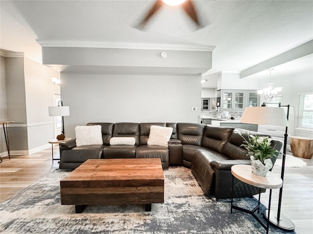 25640 State Road 70 E, Myakka City, FL 34251 - living area featuring a ceiling fan, light wood finished floors, ornamental molding, and a chandelier