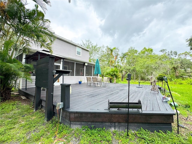 25640 State Road 70 E, Myakka City, FL 34251 - wooden terrace featuring a sunroom and outdoor dining area