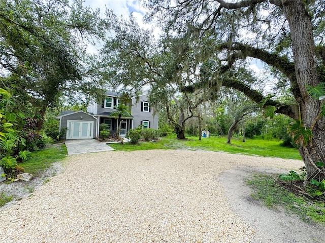 25640 State Road 70 E, Myakka City, FL 34251 - view of front facade with french doors, driveway, and a front lawn