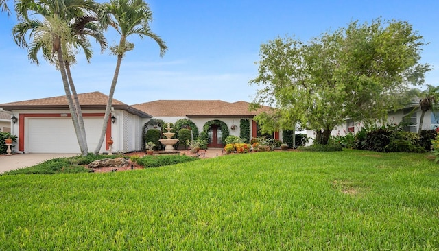 8703 53rd Ave W, Bradenton, FL 34210 - ranch-style home featuring a front yard, an attached garage, driveway, and stucco siding
