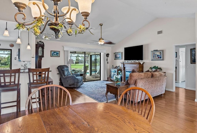 8703 53rd Ave W, Bradenton, FL 34210 - dining area featuring a ceiling fan, wood finished floors, healthy amount of natural light, and high vaulted ceiling