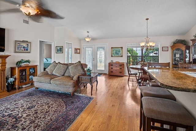 8703 53rd Ave W, Bradenton, FL 34210 - living room with light wood-style floors, lofted ceiling, a chandelier, and ceiling fan