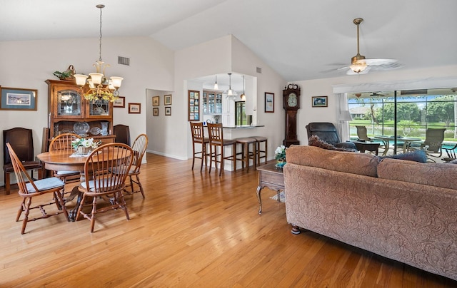 8703 53rd Ave W, Bradenton, FL 34210 - dining area with light wood-style flooring, a chandelier, ceiling fan, and high vaulted ceiling