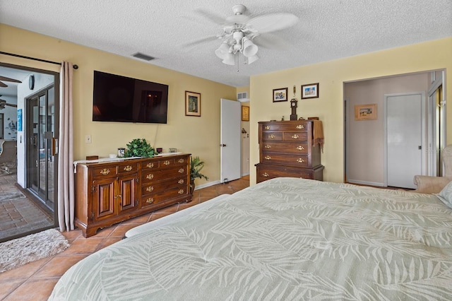 8703 53rd Ave W, Bradenton, FL 34210 - tiled bedroom with a textured ceiling, a ceiling fan, and access to outside