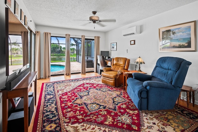 8703 53rd Ave W, Bradenton, FL 34210 - living area with a wall mounted air conditioner, ceiling fan, a textured ceiling, and wood finished floors