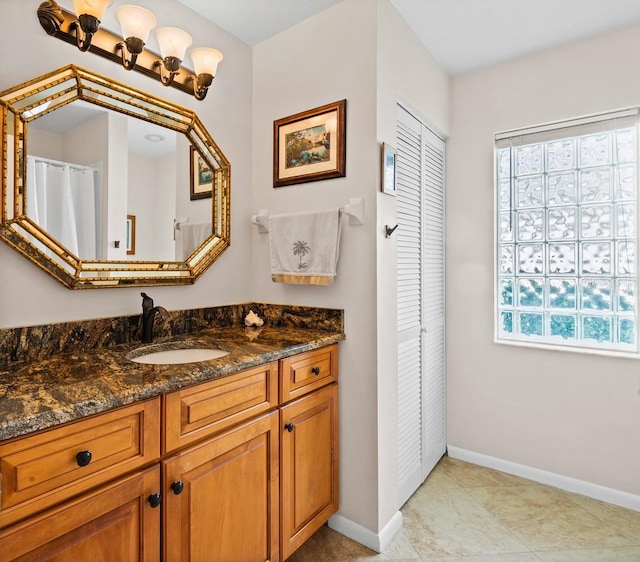 8703 53rd Ave W, Bradenton, FL 34210 - bathroom with a closet, vanity, and tile patterned flooring