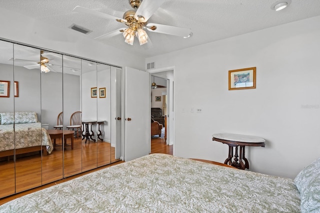 8703 53rd Ave W, Bradenton, FL 34210 - bedroom with a closet, a textured ceiling, and a ceiling fan