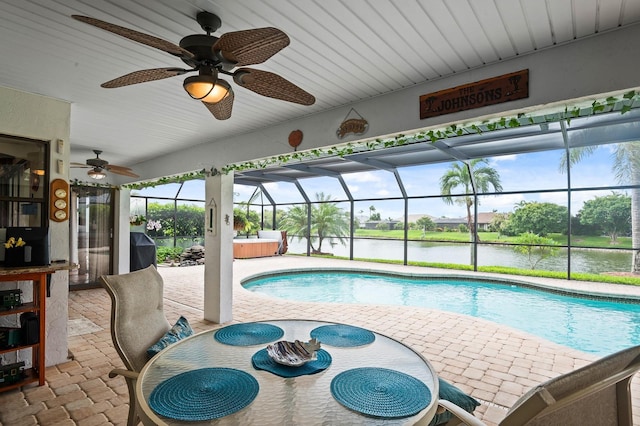 8703 53rd Ave W, Bradenton, FL 34210 - swimming pool with a hot tub, ceiling fan, a patio area, a water view, and glass enclosure