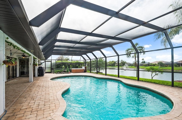 8703 53rd Ave W, Bradenton, FL 34210 - swimming pool featuring a water view, a patio, a hot tub, and a lanai