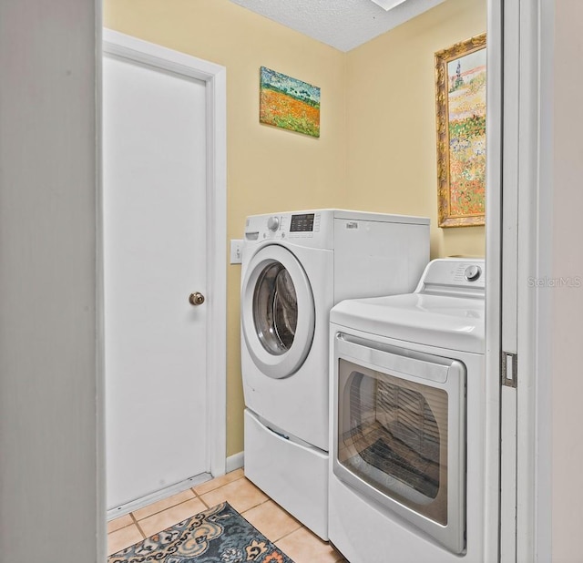 8703 53rd Ave W, Bradenton, FL 34210 - washroom with separate washer and dryer, light tile patterned floors, and a textured ceiling