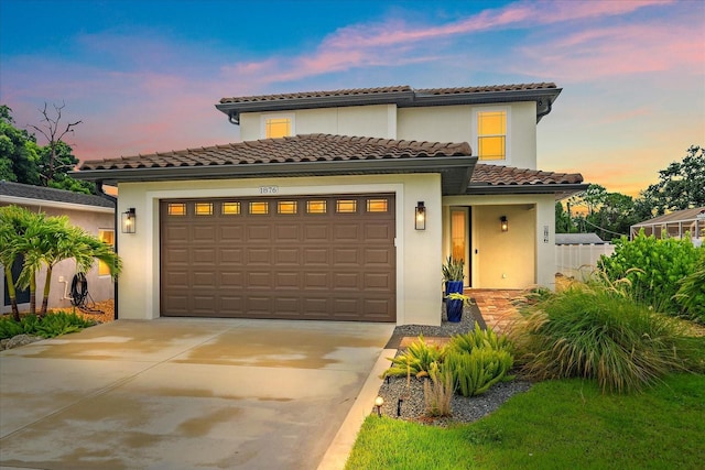 1876 Livingstone St, Sarasota, FL 34231 - mediterranean / spanish-style house featuring an attached garage, stucco siding, driveway, and a tile roof