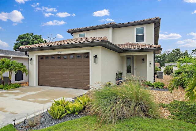 1876 Livingstone St, Sarasota, FL 34231 - mediterranean / spanish house with a garage, stucco siding, driveway, and a tiled roof
