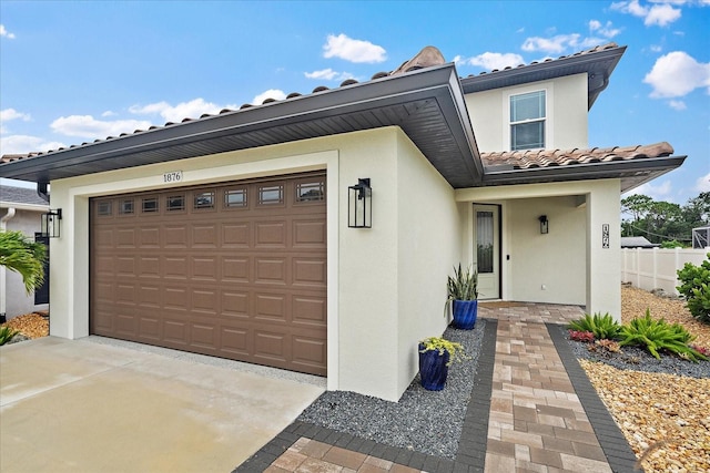 1876 Livingstone St, Sarasota, FL 34231 - view of front facade with stucco siding, a tile roof, and concrete driveway