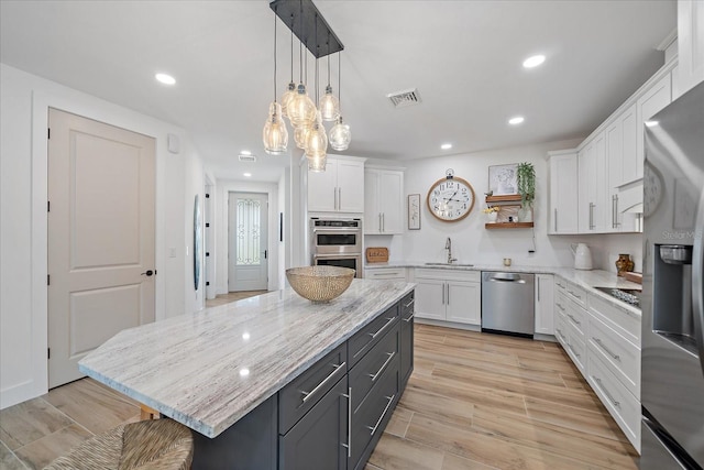 1876 Livingstone St, Sarasota, FL 34231 - kitchen featuring appliances with stainless steel finishes, white cabinets, open shelves, and recessed lighting