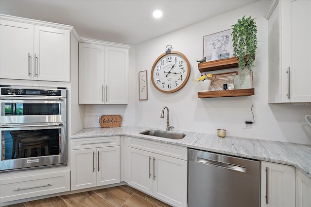 1876 Livingstone St, Sarasota, FL 34231 - kitchen featuring stainless steel appliances, white cabinetry, open shelves, recessed lighting, and light stone countertops