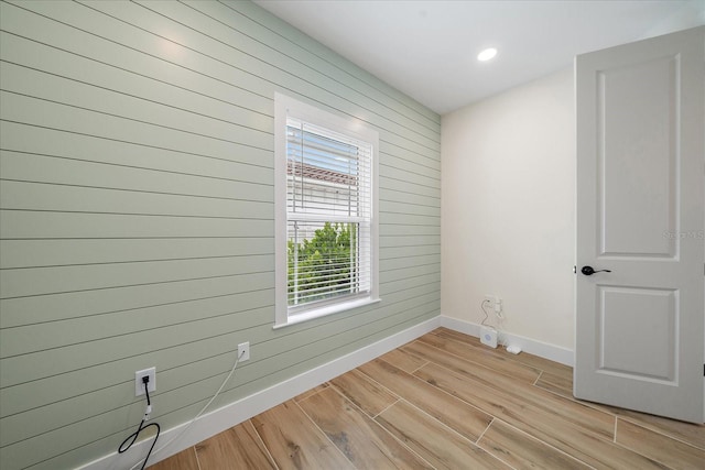 1876 Livingstone St, Sarasota, FL 34231 - empty room featuring light wood-style flooring, wood walls, and recessed lighting