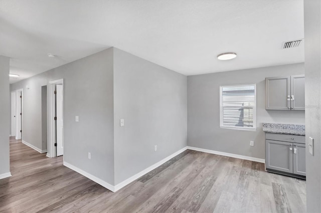 3327 King Blvd, Sarasota, FL 34234 - unfurnished living room featuring light wood-style floors and baseboards