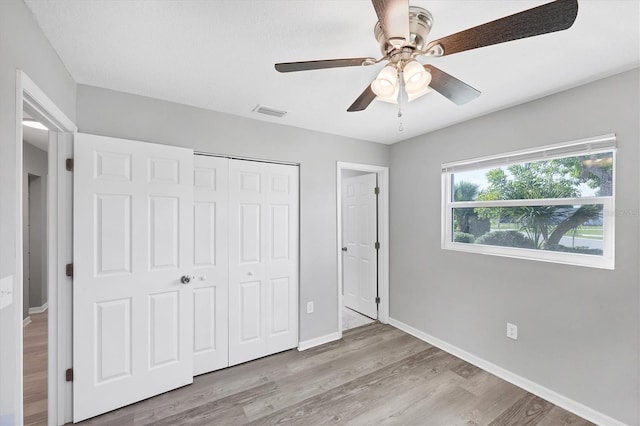 3327 King Blvd, Sarasota, FL 34234 - unfurnished bedroom with wood finished floors, a closet, and a ceiling fan