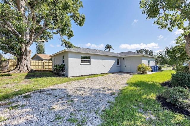 3327 King Blvd, Sarasota, FL 34234 - back of house with stucco siding and driveway