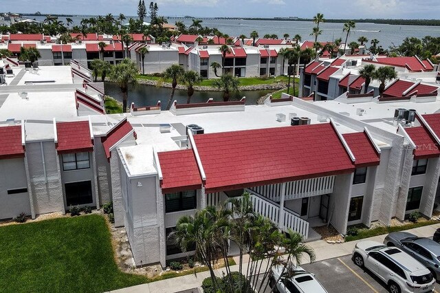 1801 Gulf Dr N Unit 276, Bradenton Beach, FL 34217 - view of property featuring a water view, a residential view, uncovered parking, and stairway