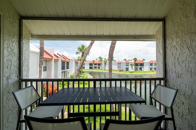 1801 Gulf Dr N Unit 276, Bradenton Beach, FL 34217 - sunroom featuring a water view and a residential view