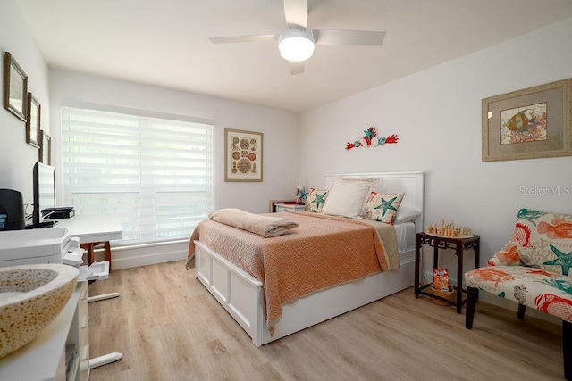 1801 Gulf Dr N Unit 276, Bradenton Beach, FL 34217 - bedroom with light wood-type flooring, a desk, and ceiling fan