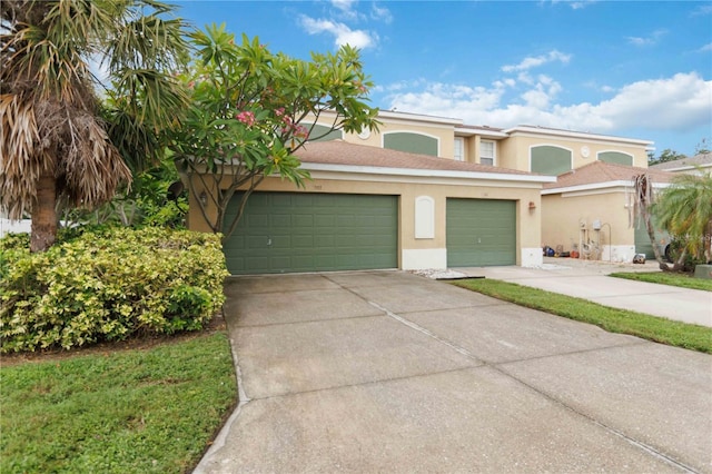2303 28th Ave E, Palmetto, FL 34221 - view of front facade with stucco siding, driveway, and a garage