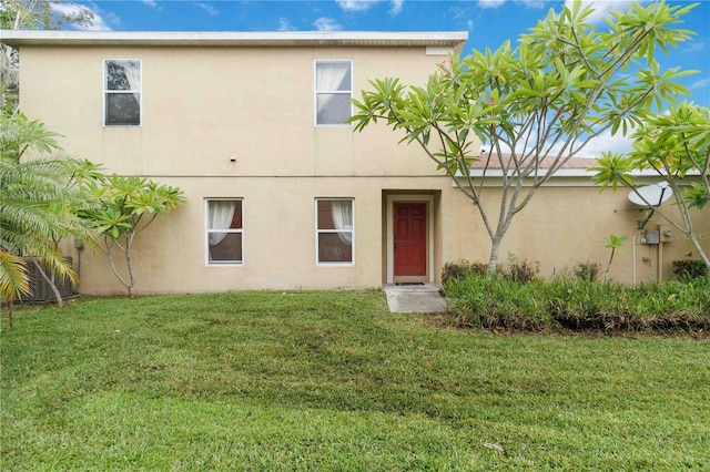 2303 28th Ave E, Palmetto, FL 34221 - back of property featuring stucco siding and a yard
