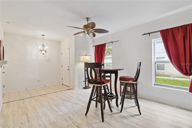 2303 28th Ave E, Palmetto, FL 34221 - dining room with light wood-type flooring, ceiling fan, and a chandelier