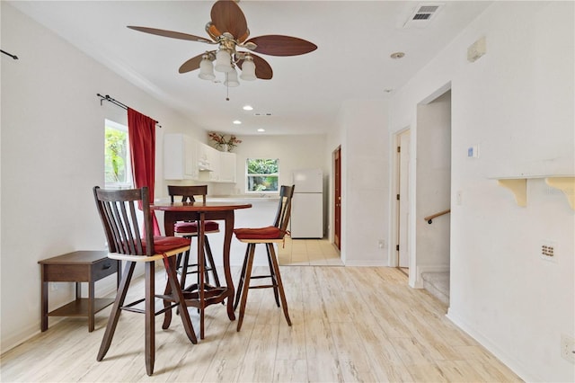 2303 28th Ave E, Palmetto, FL 34221 - dining space with light wood-style floors, a ceiling fan, and recessed lighting