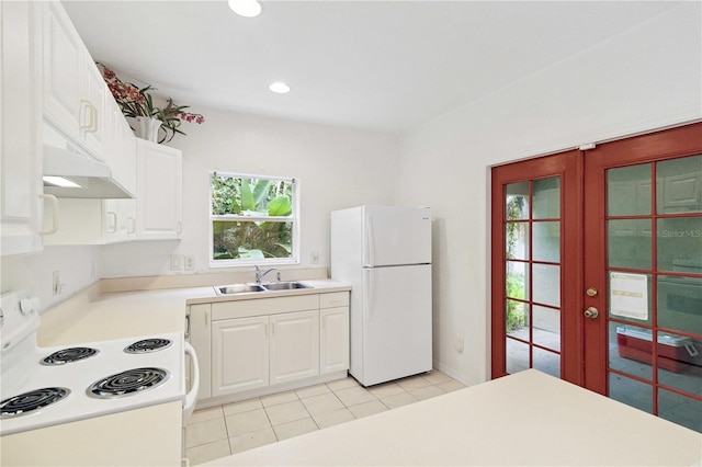 2303 28th Ave E, Palmetto, FL 34221 - kitchen with white appliances, under cabinet range hood, french doors, white cabinets, and recessed lighting