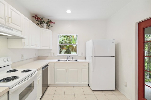 2303 28th Ave E, Palmetto, FL 34221 - kitchen featuring white appliances, under cabinet range hood, light tile patterned flooring, light countertops, and white cabinets
