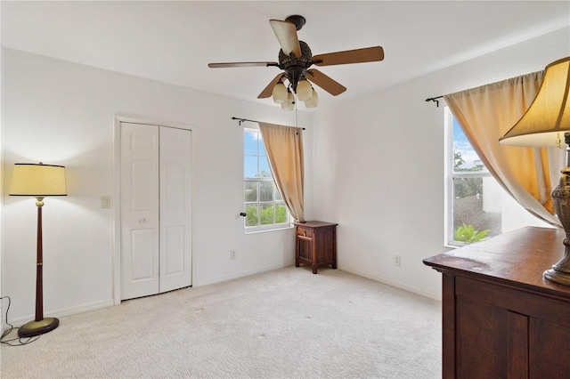 2303 28th Ave E, Palmetto, FL 34221 - unfurnished bedroom featuring light colored carpet and a ceiling fan