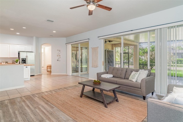5405 98th Ave E, Parrish, FL 34219 - living room featuring arched walkways, a ceiling fan, healthy amount of natural light, recessed lighting, and light tile patterned floors