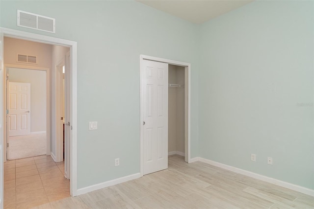 5405 98th Ave E, Parrish, FL 34219 - unfurnished bedroom with a closet and light wood finished floors