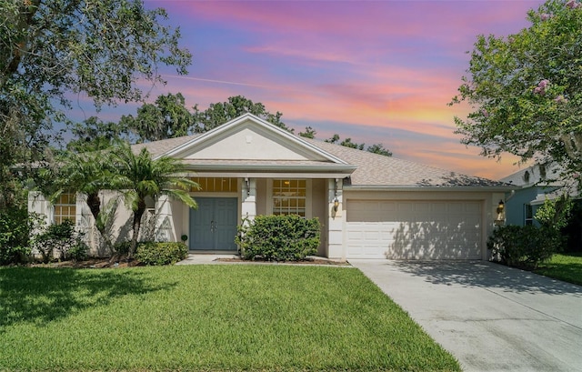 5405 98th Ave E, Parrish, FL 34219 - view of front of home with a garage, concrete driveway, a front lawn, stucco siding, and covered porch