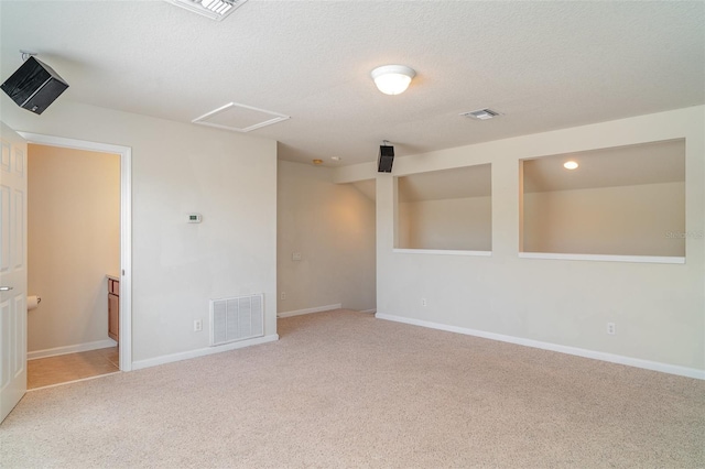 5405 98th Ave E, Parrish, FL 34219 - unfurnished room with light carpet, attic access, and a textured ceiling