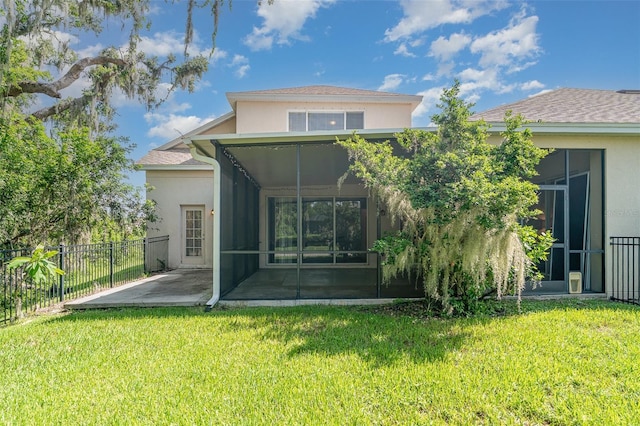 5405 98th Ave E, Parrish, FL 34219 - rear view of property featuring a sunroom, stucco siding, and a patio area