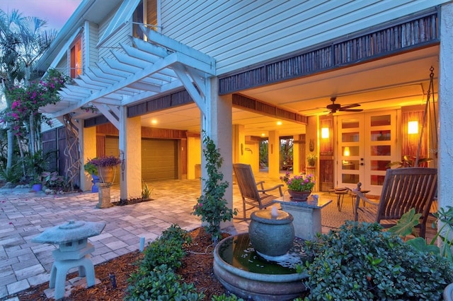701 Marbury Ln, Longboat Key, FL 34228 - patio terrace at dusk featuring french doors, a pergola, and a patio