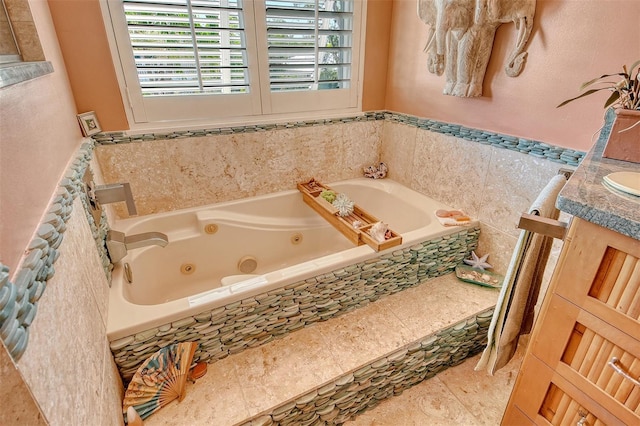 701 Marbury Ln, Longboat Key, FL 34228 - bathroom with a tub with jets, vanity, and wainscoting