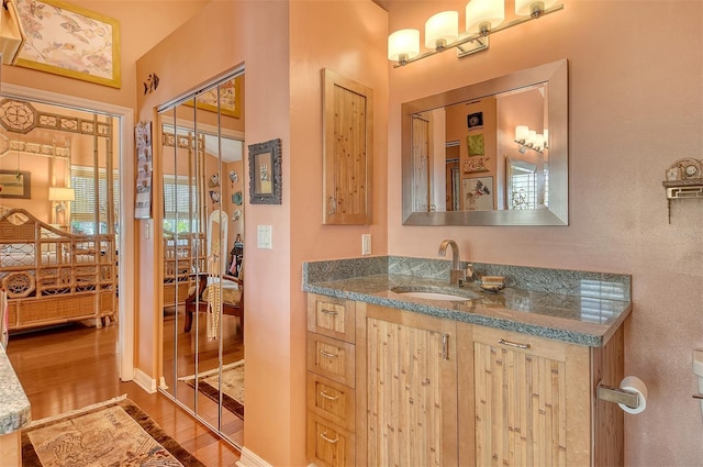 701 Marbury Ln, Longboat Key, FL 34228 - bathroom with wood finished floors and vanity