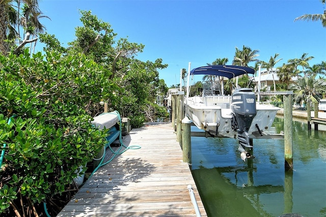 701 Marbury Ln, Longboat Key, FL 34228 - dock area featuring boat lift and a water view