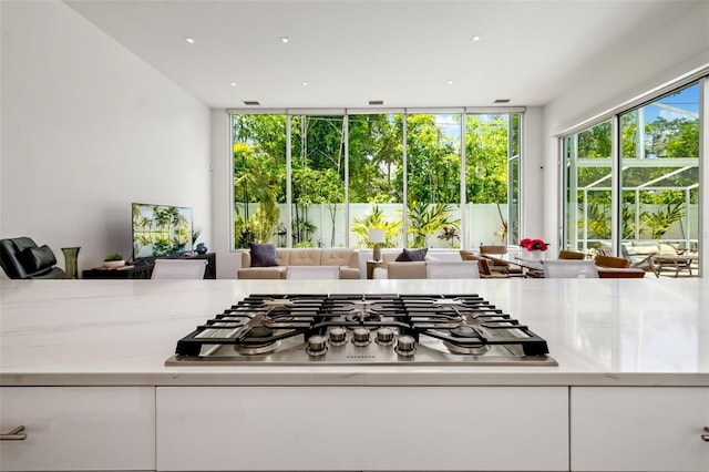 904 Virginia Dr, Sarasota, FL 34234 - kitchen featuring stainless steel gas cooktop, white cabinetry, and open floor plan