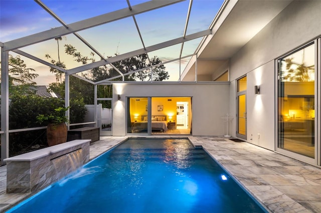 904 Virginia Dr, Sarasota, FL 34234 - pool at dusk with an outdoor pool, a patio, and glass enclosure