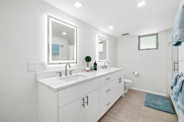904 Virginia Dr, Sarasota, FL 34234 - bathroom featuring double vanity, recessed lighting, and a shower with shower door