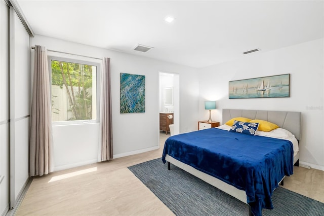904 Virginia Dr, Sarasota, FL 34234 - bedroom featuring ensuite bathroom and light wood finished floors